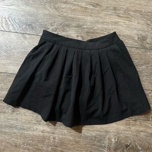 Full mini skirt w/banded waistband,zipper closure and shorts underneath.